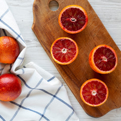Whole and halved blood oranges, top view. Flat lay, overhead, from above. Close-up.