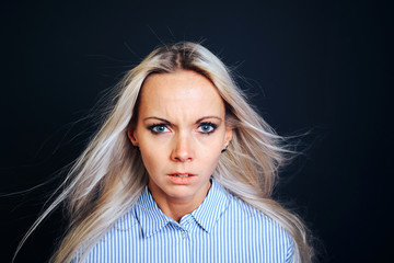 An attractive girl with developing hair and a dissatisfied expression.