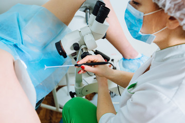 Treatment of cervical disease. Female gynecologist Unrecognizable woman patient in gynecological chair during gynecological check up. Gynecologist examines a woman. Diagnostic, medical service. - obrazy, fototapety, plakaty