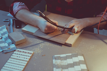 An artist using wood. Handmade use of a drill