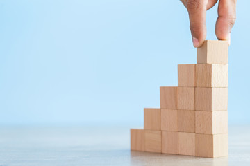 Hand Closer up hands of businessmen,stacking wooden blocks into steps,Concept of business growth success