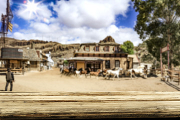 Desk of free space for your decoration. Summer city. Western architecture and running horses