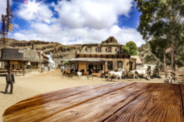 Desk of free space for your decoration. Summer city. Western architecture and running horses