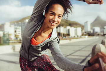 Fitness female doing leg stretches