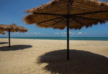 Straw umbrella on the beach for summer vacation tropics,Concept: Lifestyle for leisure travel,symbol tourism for island By the sea