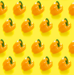 Seamless pattern with yellow peppers on yellow background. monochrome concept