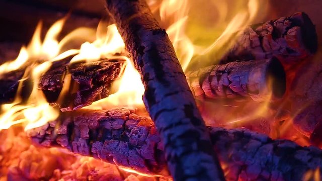 Closeup view of bright cozy burning fire inside of fireplace. Slow motion. Hd video footage.
