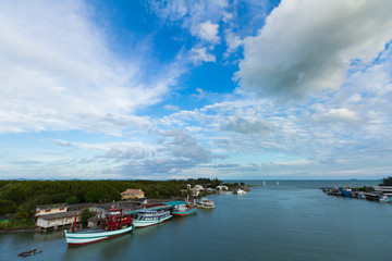 Fototapeta premium View of boat and sea and city when look from prasae bridge in the evening at rayong province , thailand.