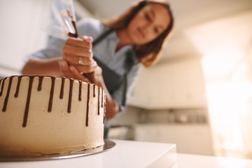 Baker decorating delicious cake