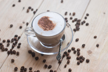 Cup with coffee on a wooden background. Coffee drink. Hot drink. Cappuccino