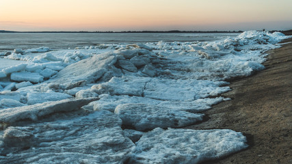 Frozen sea. Snow landscape. Sunset