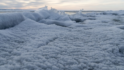 Fototapeta na wymiar Frozen sea. Snow landscape. Sunset