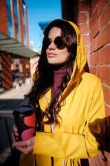 Cheerful woman in the street drinking morning coffee on New York street