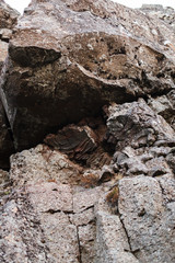 
Icelandic stones, relief slopes of a cliff in Iceland from hard rocks after the eruption