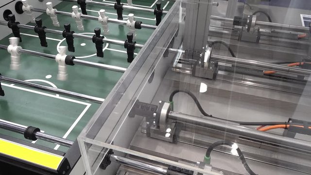 Concept of human against machine - Playing kicker against a robot with artificial intelligence