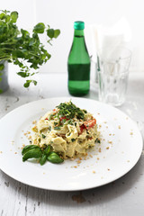 Spaghetti  pasta with cauliflower and spinach. Dish on a white plate