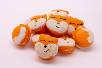 Macarons in the form of a fox on a white background