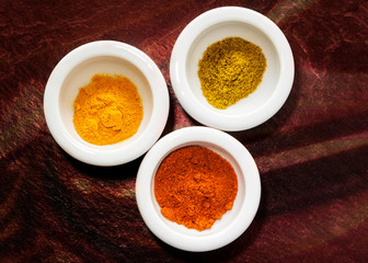 Spices on dark red backdrop