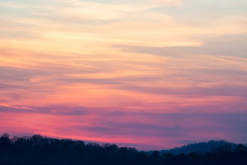 sky and clouds over hills at sunset