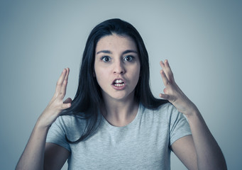 Portrait of a beautiful young woman with angry and serious face. Human expressions and emotions