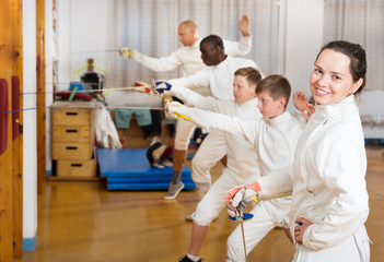 Female fencer standing in gym