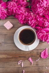 Fototapeta na wymiar Pink peony flowers gift box cup of coffee on rustic table. Mothers day or Womens day
