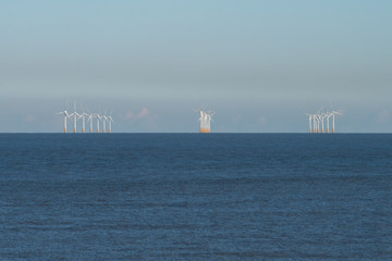 Wind farm, wind turbines out at sea