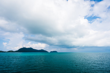 Naklejka na ściany i meble Sea and island on blue sky with cloud background