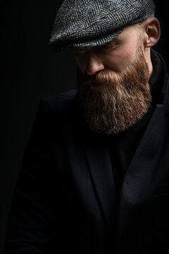 brutal man in a hat with a beard