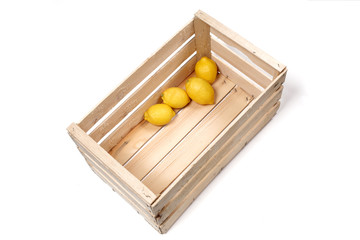 lemons in a wooden box isolated on white background with copy space for your text