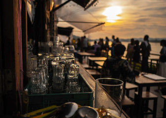 Empty glass At sunset, on the table with space for preparing for the party Along the Mekong...