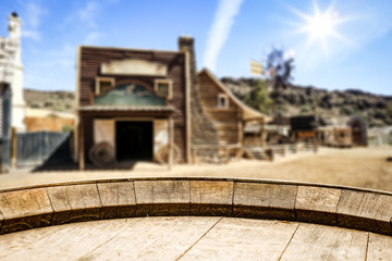 Wooden old table of free space for your product. Blurred background of Wild West city in America. 