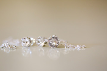 Silver earrings with crystal stone, selective focus
