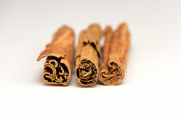 Isolated raw organic cinnamon sticks (Cinnamomum verum) from Sri Lanka. White background. Top front view.
