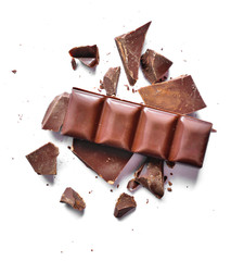 Pieces of dark chocolate, isolated on white background. Delicious bitter chocolate, top view or high angle shot.