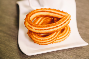 detail of spanish fritters served on a gray tablecloth