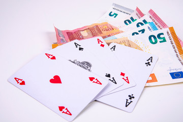 four playing card asses with euro banknotes game winnings