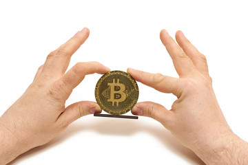 Naklejka na ściany i meble Bitcoin coin made of wood in male hands on white background