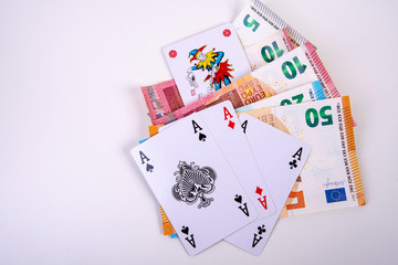 four playing cards joker and asses with euro notes