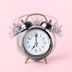 Retro alarm clock with bell, twin, showing seven o'clock