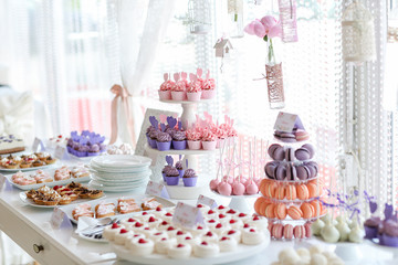 Table full with cakes and sweets at a wedding reception