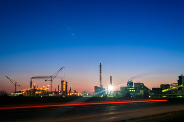 Fototapeta na wymiar chemical plant in a silhouette image at sunset, the glowing light of the chemical industry at sunset and twilight sky, the field of chemistry