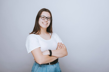 Happy young girl smiling with crossed arms. Confident student.