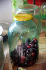 Pouring sour cherry jam into a jar