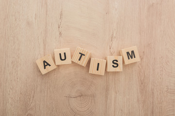 top view of autism lettering made of wooden blocks