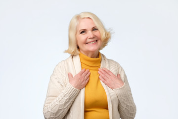 Pretty senior blonde woman is touched with compliment