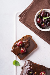 Chocolate pound cake with glaze and fresh berries. Overhead.