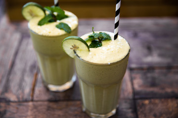 Morning healthy breakfast smoothie drink made of super foods, fruits, mint.