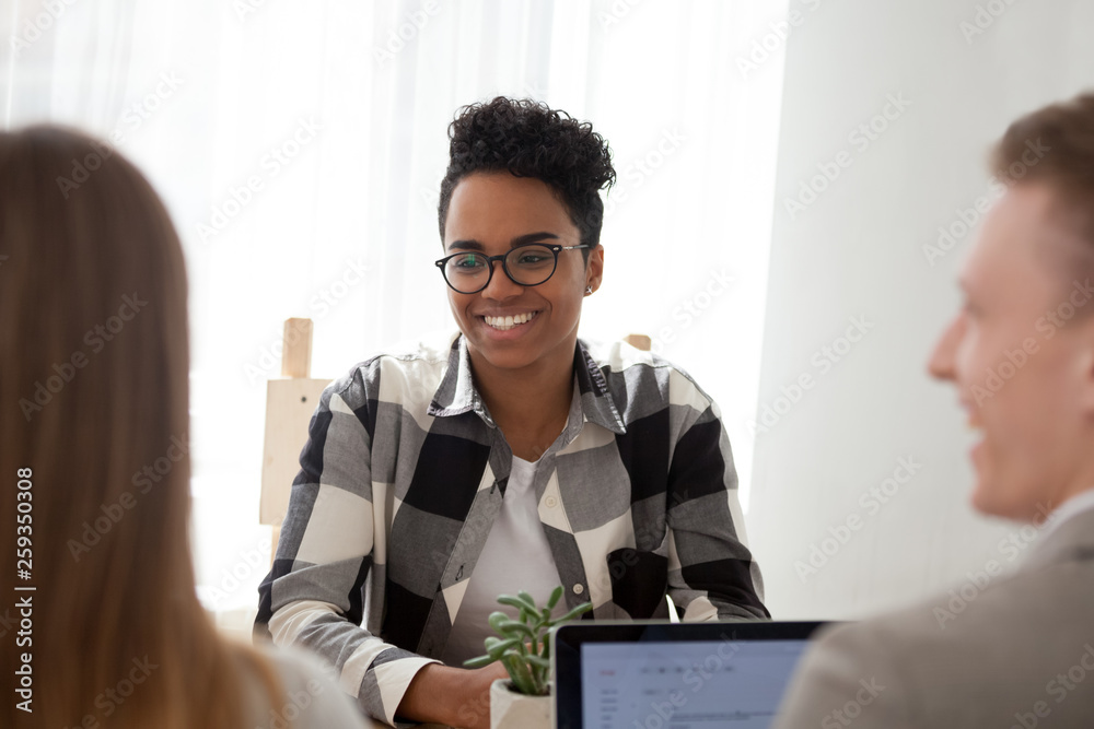 Sticker Black woman sitting together with colleagues in office