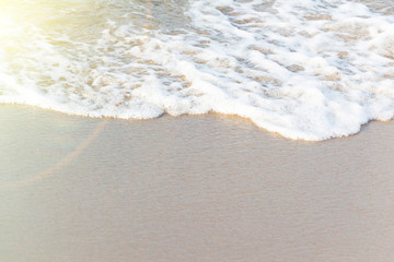 Soft wave of ocean on sandy beach. Nature background. Flat lay concept. Place for your text.